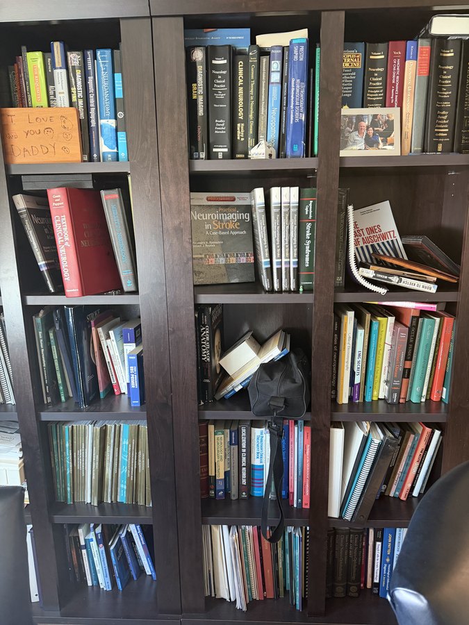 Neurology shelf with the I Love You Daddy plaque next to Bradley's textbook.