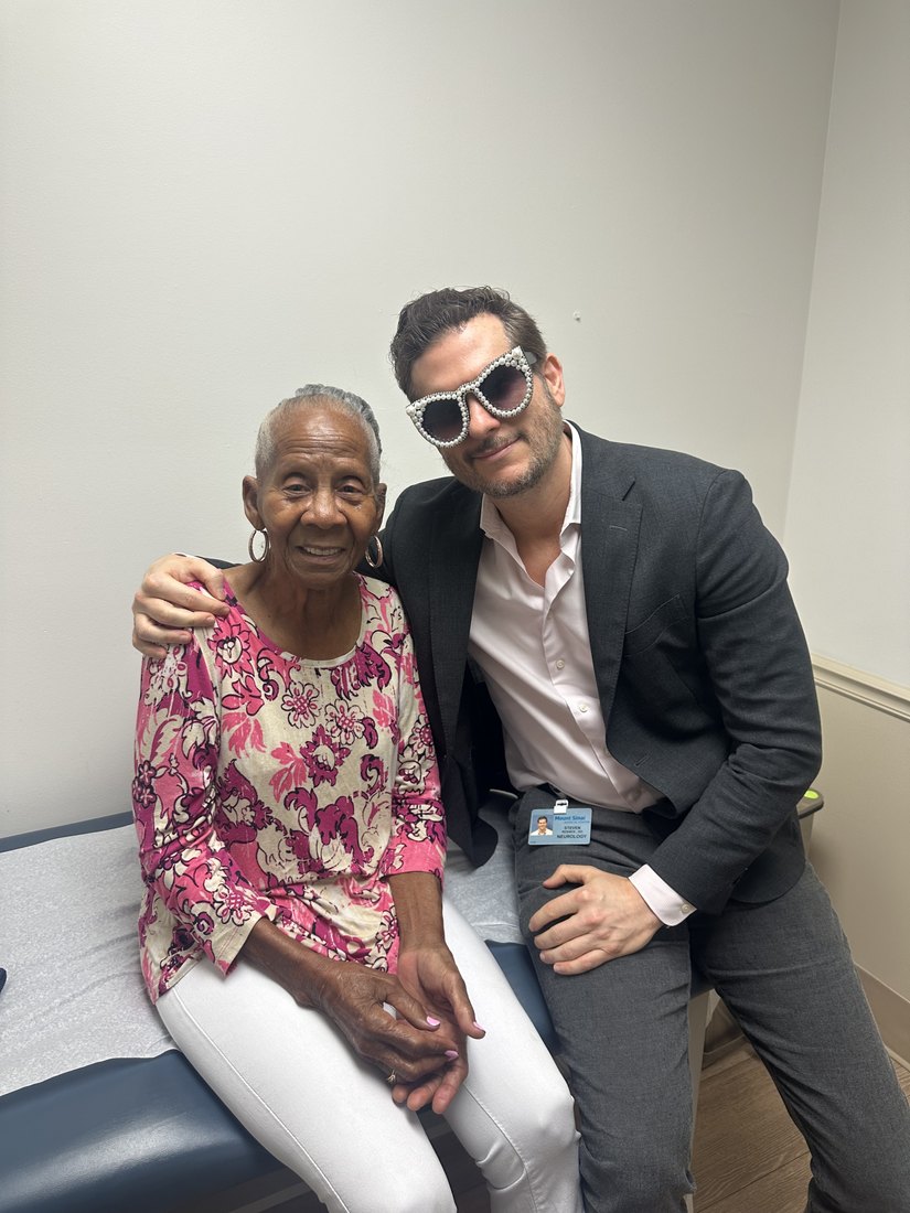 Patient wearing pearl sunglasses in the exam room.